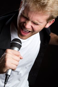 Young man singing into microphone