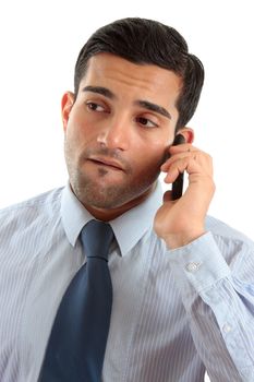 A businessman on a mobile cellphone, is considering or thinking, perhaps listening intently.   White background.