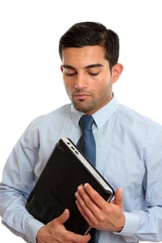 A businessman, or IT consultant holding a laptop computer.  White background.