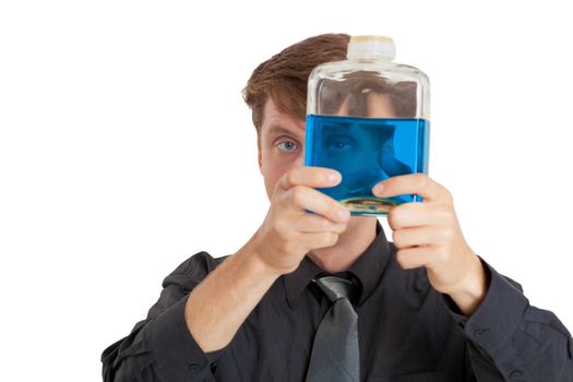 A man checks the physical properties of the liquid in the bottle