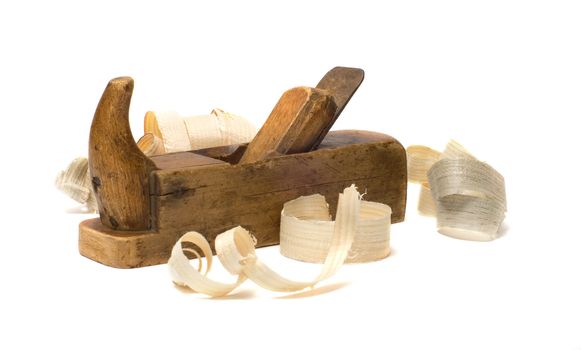 Old wooden plane and chips on a white background.