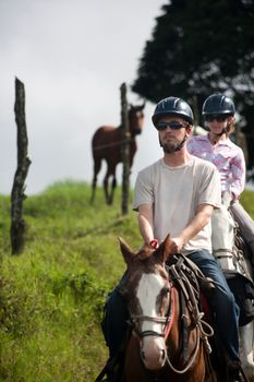 Equestrian couple on horses ranch in Costa Rica