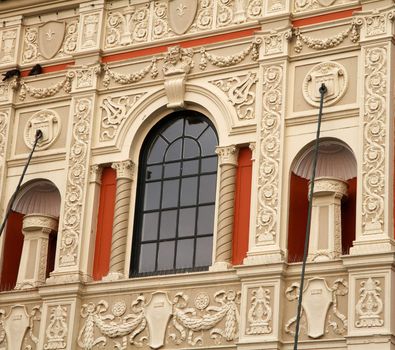 Onate tan Old Theater Facade with ocre time and windwo