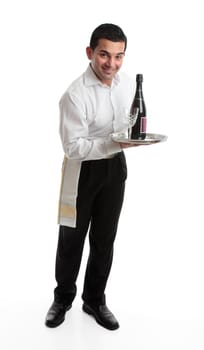 A smiling friendly waiter, bartender, or domestic staff, holding or presenting a tray with a bottle of  wine and glasses.  White background.