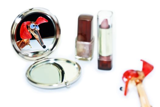 Glass dachshund looking in the make-up mirror