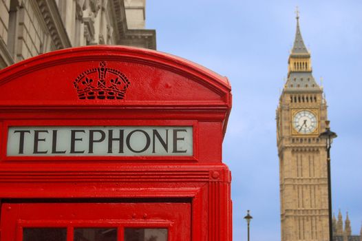 Big Ben and telephone cabin in London over blue sky 