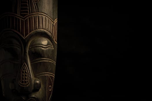 African mask over black background with copy space