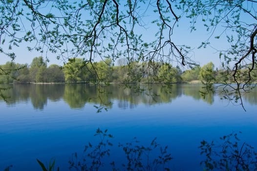 Mystic lake landscape with deep blue water