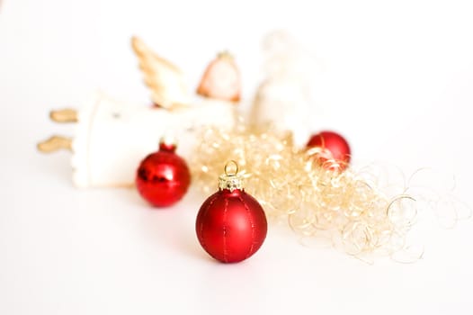 three red christmas balls and an angel with golden decoration