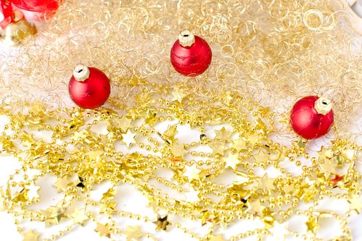 three red christmas balls with golden decoration