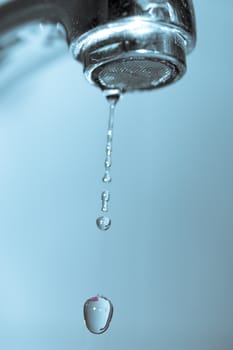 Water dripping from water faucet, closeup