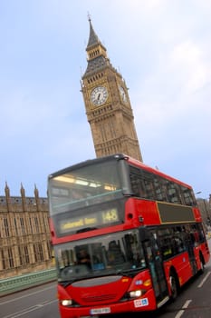 Big Ben and bus in London over blue sky