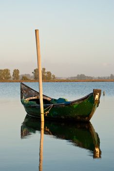 View of a traditional fishing boat anchored on water.