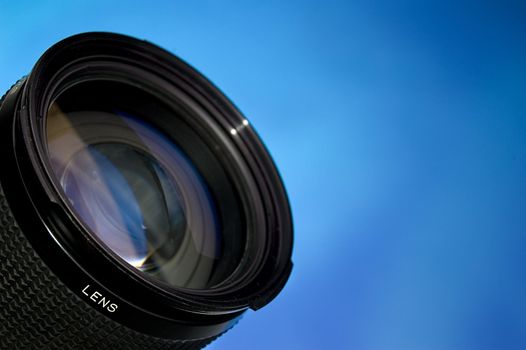 Photograpy lens over abstract blue background.