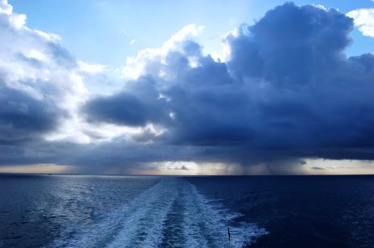 Dark stormy clouds. View form car ferry