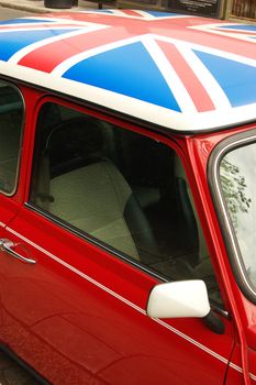 Red car with english flag on roof