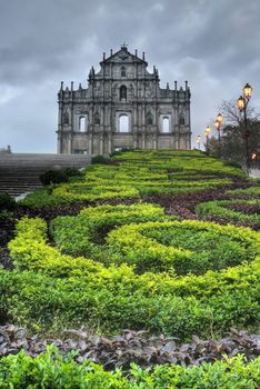 Macao landmark, ruins of St. Paul's Cathedral with green park in night in Macau, China.