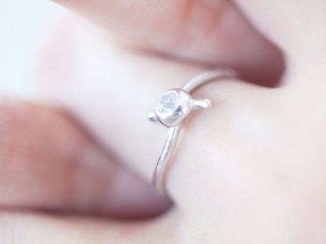 Macro of a ring on a young woman hand