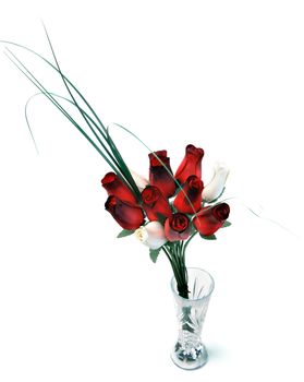 A bouquet of wooden roses in a glass vase, isolated against a white background