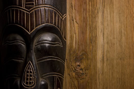 African mask over wooden background with copy space