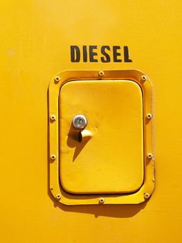 Yellow diesel tank  door on the side of a bus
