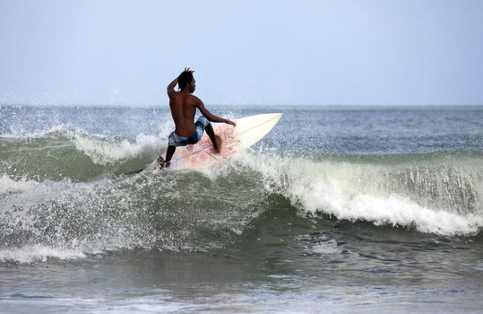 Young men - the surfer in ocean. Bali. Indonesia