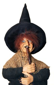 Witch with broom and hat. Isolated.
Horror, halloween, fantasy photo.