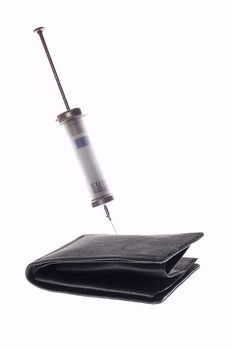 Cash injection or medical costs concept -  syringe with money inside