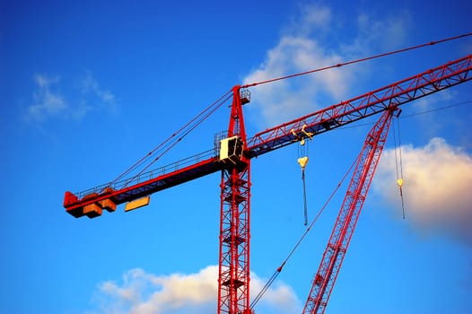 Big red construction crane in London. Over blue sky