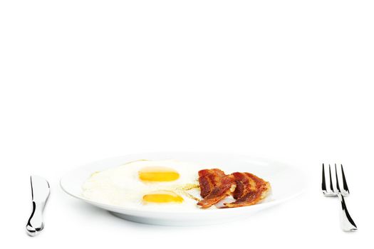 fried eggs and bacon on a plate on white background