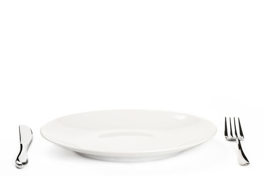 white plate with cutlery on white background