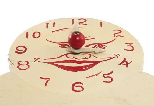A low angle view of an old handcrafted wood toy clock face isolated on white with clipping path. Hand painted white with red numerals and a face at the center.