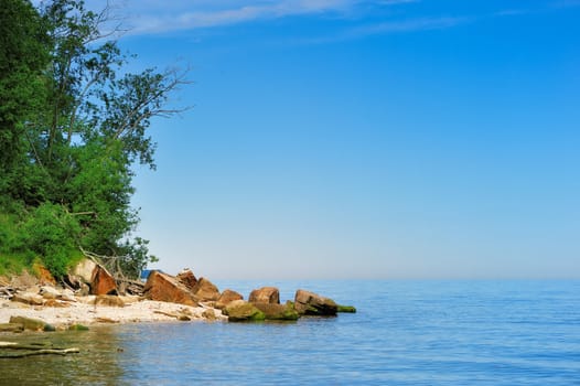 Sea coast with boulders in the summer day