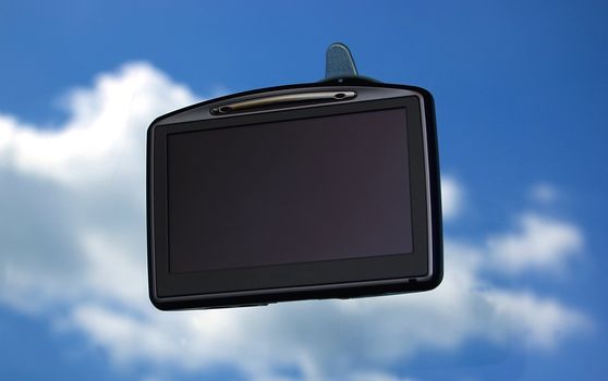 GPS on car window over blue sky