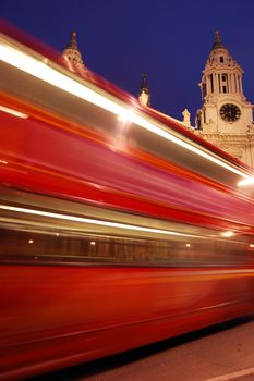 Blurred red London bus. St Paul's Cathedral in background