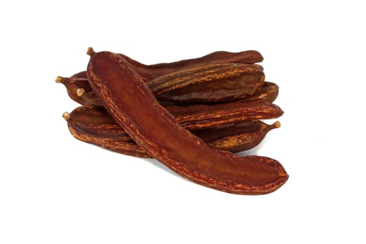 Bunch of dried carob isolated on white