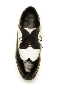 Two-tone black and white patent leather men's shoe on white
