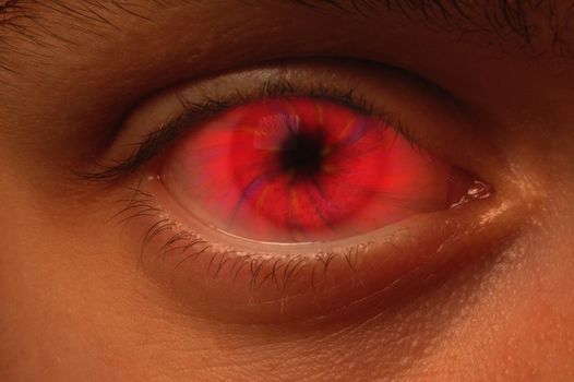 Close-up of eyeball with a red vortex