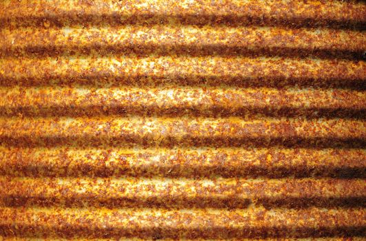 Closeup of rusty corrugated metal can surface 