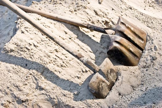 building series: two shovel in the sand heap