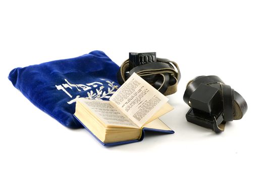 Tefillin - phylacteries worn by Jewish men for morning prayers, Siddur - Jewish prayerbook and bag isolated on white 