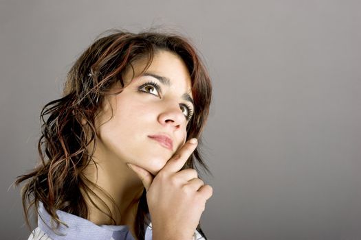 Portrait of a beautiful young and attractive woman thinking in something