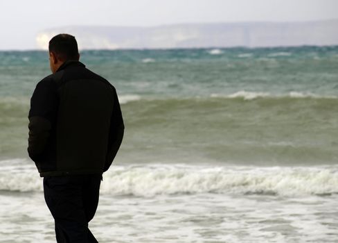 Lone man in deep thought during rough winter weather