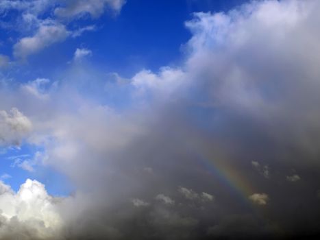 Real rainbow formed during rainfall, symolising gay pride and homosexuality