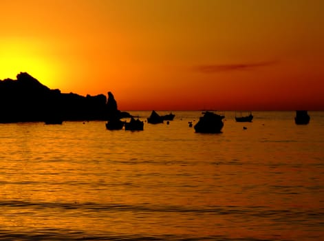 Typical Mediterranean sunset in a tranquil beach in Malta.