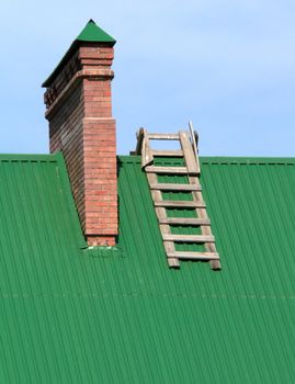 The stairway on roof of the building with pipe.