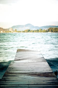 vertical footbridge, lake and mountains view
