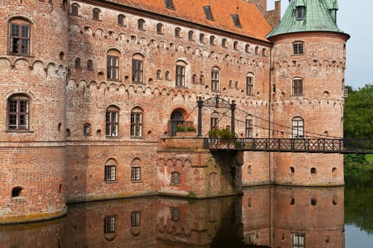 Egeskov castle slot landmark fairy tale castle in Funen Denmark view and details from the back garden and bridge