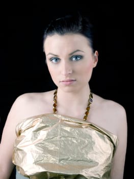 Young beautiful woman on black background. Woman have blue eyes and dark hair.