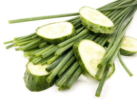 Fresh chives and sliced cucumber on white background